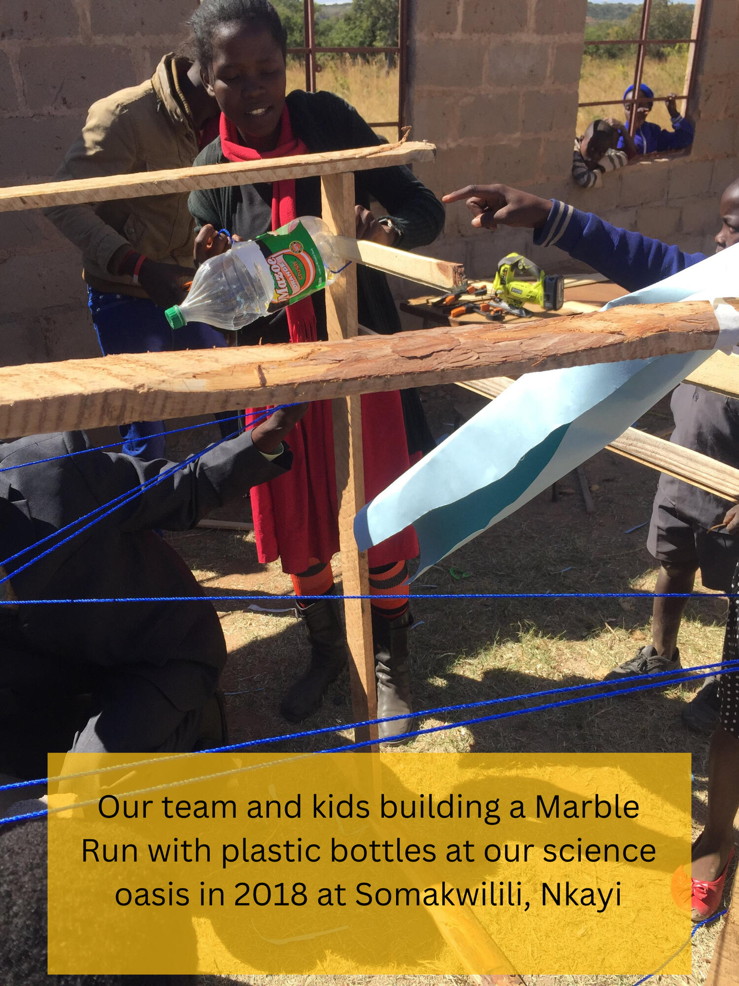 Our team and kids building a marble run using plastic bottles.